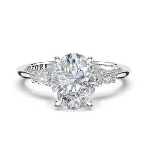 2685ov Platinum three stone ring, top view: oval center stone flanked by pear side stones with milgrain shoulders