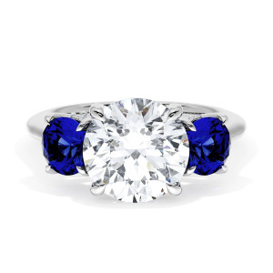 41127RD9BS Platinum top view, round brilliant center stone between two round blue sapphires on a polished platinum band