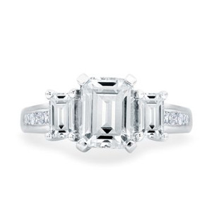 A.JAFFE MES690/241 14 Karat engagement ring, white gold top view of the emerald cut three stone head above channel set shoulders