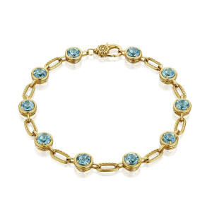 Tacori FB825RD5BTY 18 Karat Yellow Gold, top view of the bracelet with ten round blue topaz stations in bezel rims, milgrain oval links and lobster clasp