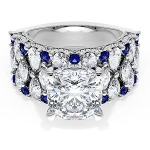 21CU9BS112 Platinum top view: cushion center stone over a triple-row band of diamonds and round blue sapphires