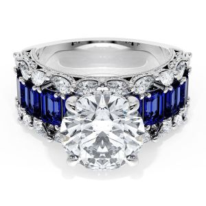23RD10BS212 Platinum top view, round brilliant center over a row of emerald cut blue sapphires with diamond borders