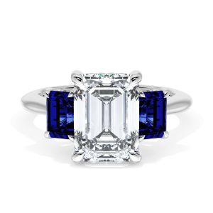 41127EC95X7BS Platinum top view, emerald cut center with step cut blue sapphire side stones on a polished white metal band