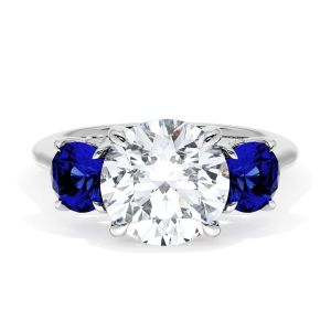 41127RD9BS Platinum top view, round brilliant center stone between two round blue sapphires on a polished platinum band