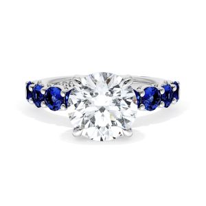 415RD9BS Platinum top view, round brilliant center on a band of round blue sapphires in milgrain pockets
