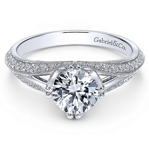 Gabriel & Co. ER6946W44JJ 14 karat white gold engagement ring, front view of a round center held by paired prongs above a shank splitting into pave rails