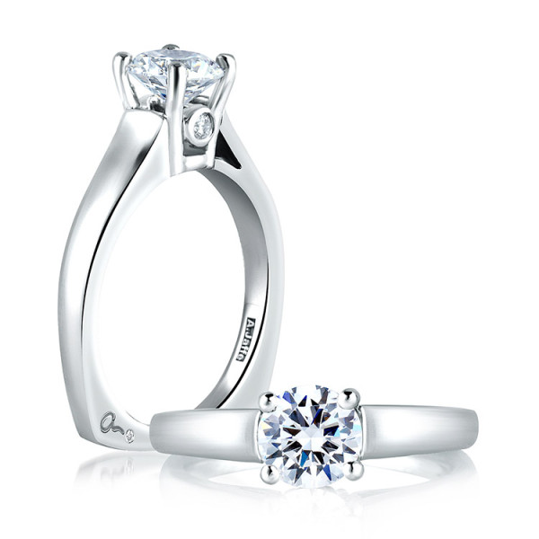 A.JAFFE MES063/04 14 Karat engagement ring, angled view of a four prong round center with a bezel set accent beneath a broad tapered shank