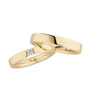 Christian Bauer 241689 14 karat yellow gold diamond wedding band, angled view of a polished flat face whose open ends hold one round stone in four small prongs, shown with its matching ring