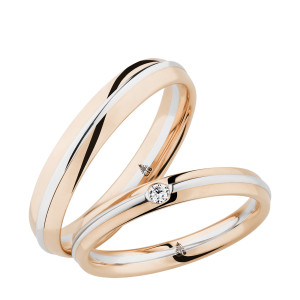 Christian Bauer 241705 two-tone platinum and 18 karat gold diamond wedding band, angled view of a polished rose profile with a slim platinum rail along one edge and a bezel set stone, shown with its matching ring