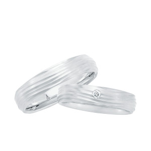 Christian Bauer 241732 platinum diamond wedding band, angled view of a matte surface cut with irregular wave grooves and one round stone flush set on top, shown with its matching ring