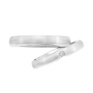 Christian Bauer 241738 14 karat white gold diamond wedding band, profile view of a brushed satin dome with one small round stone set in a diagonal slot at the top, shown with its matching ring