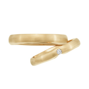 Christian Bauer 241738 14 karat yellow gold diamond wedding band, profile view of a brushed satin dome with one small round stone set in a diagonal slot at the top, shown with its matching ring