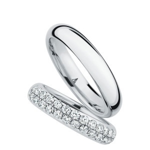 Christian Bauer 246948 platinum diamond wedding band, angled view of a polished rounded profile fully set with two staggered rows of round stones in shared prongs, shown with its matching ring