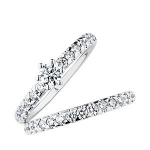 Christian Bauer 246950 14 karat white gold diamond wedding band, angled view of a polished rounded profile set all the way around with round stones in scalloped shared prongs, shown with its matching ring