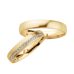 Christian Bauer 246961 18 karat yellow gold diamond wedding band, angled view of a satin dome with a channel set line of tiny stones along one edge halfway around, shown with its matching ring
