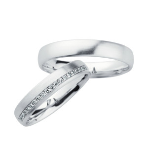 Christian Bauer 246961 platinum diamond wedding band, angled view of a satin dome with a channel set line of tiny stones along one edge halfway around, shown with its matching ring