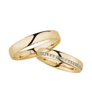Christian Bauer 246964 14 karat yellow gold diamond wedding band, angled view of a polished dome with a channel set line of tiny stones cutting diagonally across the face, shown with its matching ring