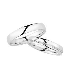 Christian Bauer 246964 18 karat white gold diamond wedding band, angled view of a polished dome with a channel set line of tiny stones cutting diagonally across the face, shown with its matching ring