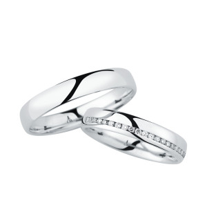 Christian Bauer 246964 platinum diamond wedding band, angled view of a polished dome with a channel set line of tiny stones cutting diagonally across the face, shown with its matching ring
