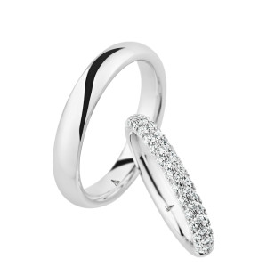 Christian Bauer 246974 14 karat white gold diamond wedding band, angled view of a rounded profile paved all around with three rows of small stones over the whole outer surface, shown with its matching ring