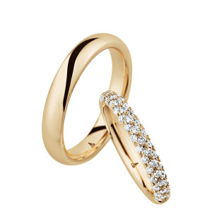 Christian Bauer 246974 14 karat yellow gold diamond wedding band, angled view of a rounded profile paved all around with three rows of small stones over the whole outer surface, shown with its matching ring