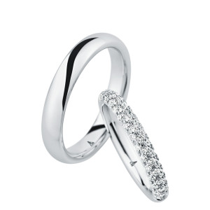 Christian Bauer 246974 platinum diamond wedding band, angled view of a rounded profile paved all around with three rows of small stones over the whole outer surface, shown with its matching ring