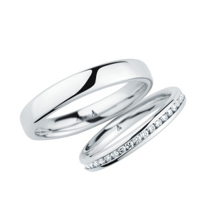Christian Bauer 246975 platinum diamond wedding band, angled view of a polished rounded profile with a full channel set row of small stones offset toward one edge, shown with its matching ring