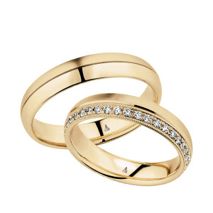 Christian Bauer 247042 14 karat yellow gold diamond wedding band, angled view of a brushed flat face with a milgrain edged row of small bead set stones along one side, shown with its matching ring