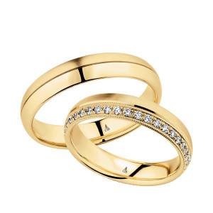 Christian Bauer 247042 18 karat yellow gold diamond wedding band, angled view of a brushed flat face with a milgrain edged row of small bead set stones along one side, shown with its matching ring