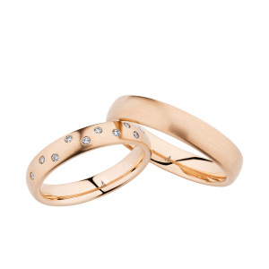 Christian Bauer 247049 18 karat rose gold diamond wedding band, angled view of a satin dome with pairs of small stones flush set at intervals around the face, shown with its matching ring