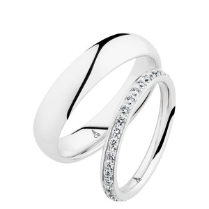 Christian Bauer 247064 14 karat white gold diamond wedding band, angled view of a softly rounded profile with a continuous row of small bead set stones between polished edges, shown with its matching ring