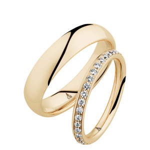 Christian Bauer 247064 14 karat yellow gold diamond wedding band, angled view of a softly rounded profile with a continuous row of small bead set stones between polished edges, shown with its matching ring