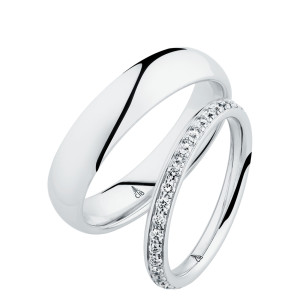 Christian Bauer 247064 platinum diamond wedding band, angled view of a softly rounded profile with a continuous row of small bead set stones between polished edges, shown with its matching ring
