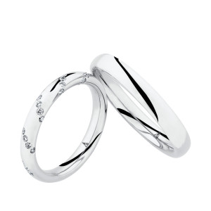 Christian Bauer 247083 18 karat white gold diamond wedding band, angled view of a polished rounded profile scattered with small flush set stones in loose diagonal clusters, shown with its matching ring