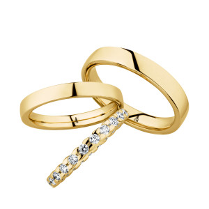 Christian Bauer 247099 18 karat yellow gold diamond wedding band, angled view of a rounded profile fully set with larger round stones in shared prongs meeting edge to edge, shown with its matching rings