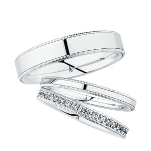 Christian Bauer 247107 platinum diamond wedding band, angled view of a flat profile with a bright row of round bead set stones framed by milgrain rails, shown with its matching rings
