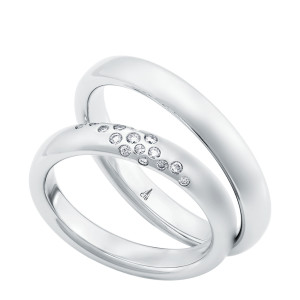 Christian Bauer 247110 platinum diamond wedding band, angled view of a matte domed profile with a scattered diagonal cluster of small flush set stones, shown with its matching ring