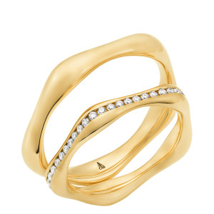 Christian Bauer 247145 18 karat yellow gold diamond wedding band, angled view of a polished sculpted profile with a wavy outline and a channel of small stones following the wave, shown with its matching ring