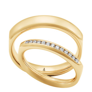 Christian Bauer 247146 18 karat yellow gold diamond wedding band, angled view of a polished softly squared outline with a straight channel of small stones across the front, shown with its matching ring
