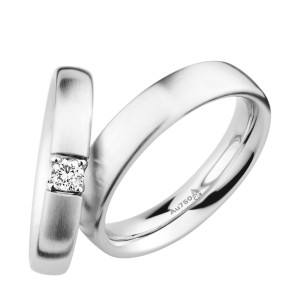 Christian Bauer 270980 14 karat white gold wedding band, angled view of a softly domed satin brushed surface with rounded edges flowing into a bright polished interior, shown with its matching ring