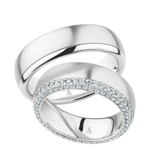 Christian Bauer 274314 18 karat white gold wedding band, angled view of a satin brushed dome beside a polished rounded edge rail divided by a fine incised line, shown with its matching ring