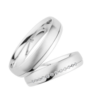 Christian Bauer 274391 18 karat white gold wedding band, angled view of a satin brushed dome with a single polished incised line near one rounded edge, shown with its matching ring