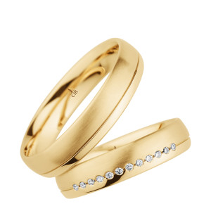 Christian Bauer 274391 18 karat yellow gold wedding band, angled view of a satin brushed dome with a single polished incised line near one rounded edge, shown with its matching ring