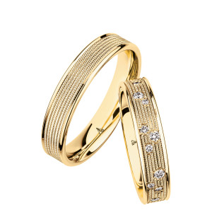 Christian Bauer 274430 18 karat yellow gold wedding band, angled view of a flat face filled with many rows of fine milgrain beading between narrow polished stepped rims, shown with its matching ring