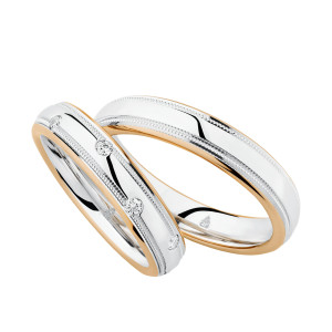 Christian Bauer 274507 two-tone 14 karat gold wedding band, angled view of a polished white domed center with a milgrain line inside each narrow rose rim, shown with its matching ring