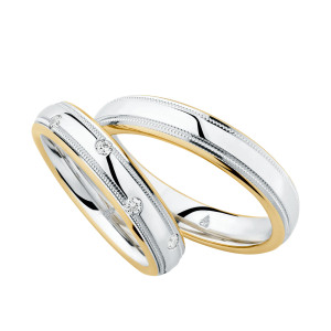 Christian Bauer 274507 two-tone 18 karat gold wedding band, angled view of a polished white domed center with a milgrain line inside each narrow yellow rim, shown with its matching ring