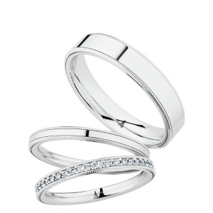 Christian Bauer 274663 18 karat white gold wedding band, angled view of a flat polished face bordered by a fine milgrain rail along each edge, shown with its matching rings