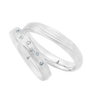 Christian Bauer 274783 18 karat white gold wedding band, angled view of a matte dome carved with fine flowing wave grooves that wrap around the surface into rounded edges, shown with its matching ring