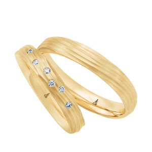 Christian Bauer 274783 18 karat yellow gold wedding band, angled view of a matte dome carved with fine flowing wave grooves that wrap around the surface into rounded edges, shown with its matching ring