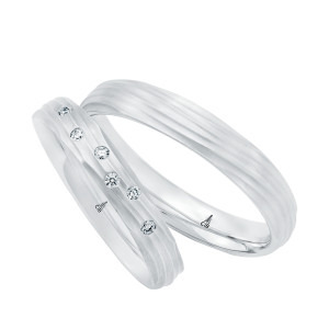 Christian Bauer 274783 platinum wedding band, angled view of a matte dome carved with fine flowing wave grooves that wrap around the surface into rounded edges, shown with its matching ring